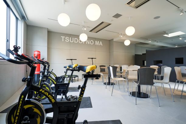 [可児キャンパス TSUDOI NO MA]：エアロバイクなどの運動機器や自習室、カフェエリアがある複合スペースです。